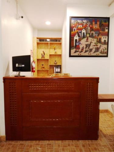 a wooden altar in a room with a picture on the wall at Lunandina Huaraz in Huaraz