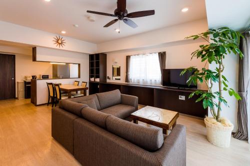 a living room with a couch and a table at MINATO Chatan Seaside Condominium in Chatan
