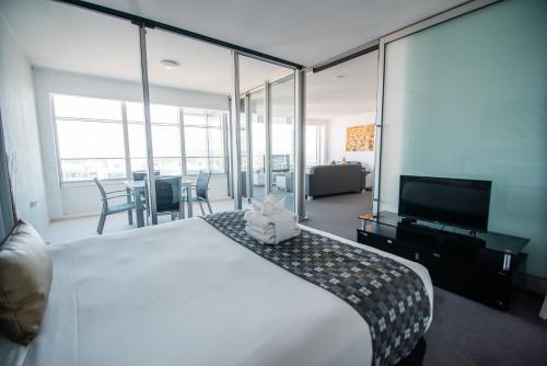 a hotel room with a large bed and a large window at Q1 Resort & Spa - Official in Gold Coast