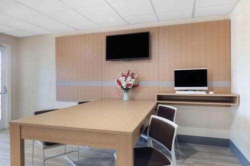 a conference room with a table with chairs and a tv at Microtel Inn & Suites by Wyndham Florence in Florence