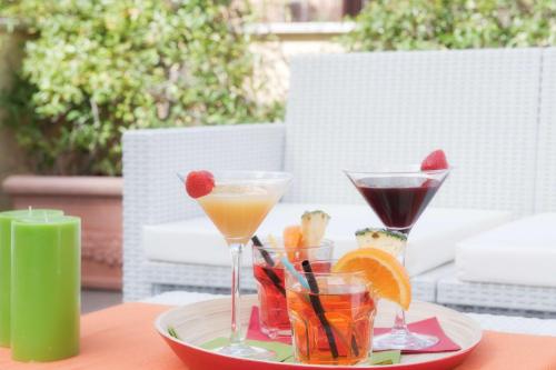 a plate with two martini glasses on a table at Best Western Ars Hotel in Rome