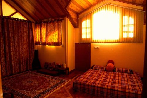 a bedroom with two beds and a window at AMBIKA HOME STAY in Solan
