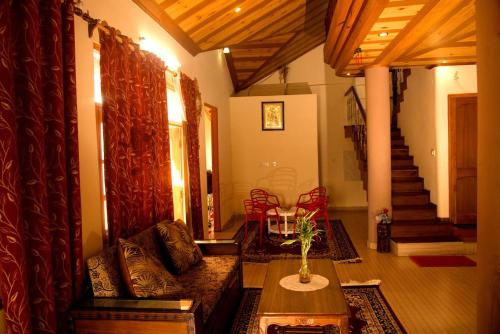 a living room with a couch and a table at AMBIKA HOME STAY in Solan