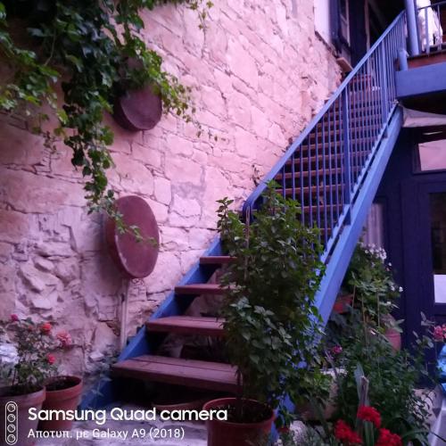 a staircase leading up to a building with flowers at Ble Mavi - Studio for 2 in Vouni