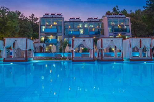 a rendering of a hotel with a swimming pool at night at Orka Cove Hotel Penthouse & Suites Adults Only in Fethiye