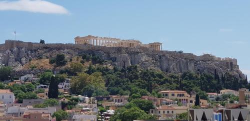 a castle on top of a mountain above a city at Athens Utopia Ermou in Athens