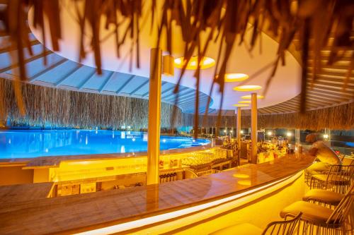 a large swimming pool in a building with a resort at Orka Cove Hotel Penthouse & Suites Adults Only in Fethiye