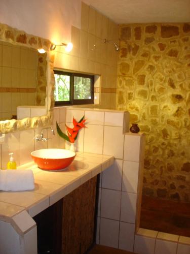 a bathroom with a sink and a mirror at Mundo Milo Eco Lodge in Playa Junquillal