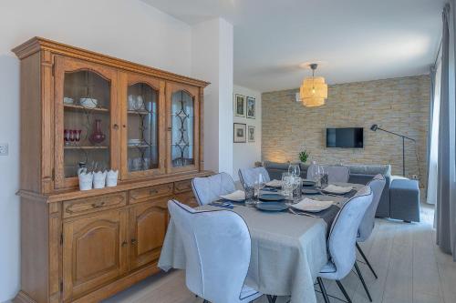 a dining room with a table and blue chairs at Premium 100m2 sea view apartment in Ližnjan