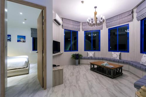 a living room with a bed and a couch and a table at Costa Village Bangsaray in Bang Sare
