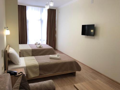 Un pat sau paturi într-o cameră la Hotel Belugo