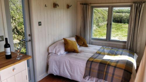 a bedroom with a bed and a window at The Wheelhouse in Bude