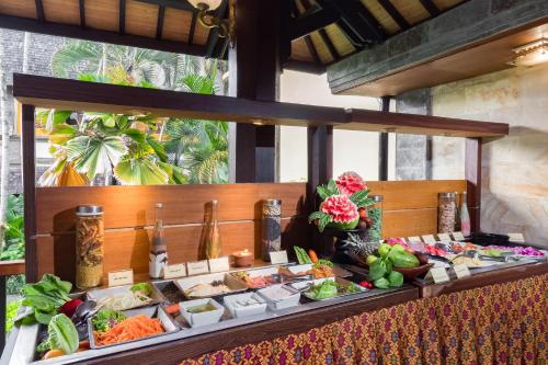 a buffet of food on a table at a resort at Hotel Vila Lumbung in Seminyak
