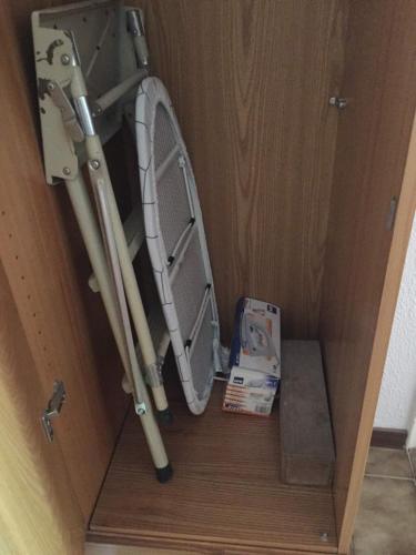 a wooden cabinet with twoadders and a box in it at Casa Mia in Lurisia