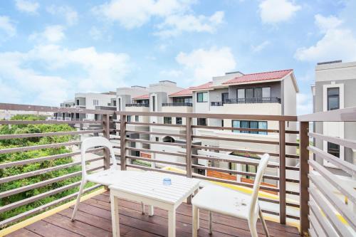 a balcony with two chairs and a table at Seaway in Magong