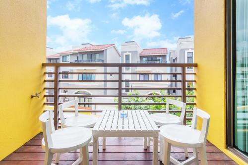 a patio with a table and chairs on a balcony at Seaway in Magong