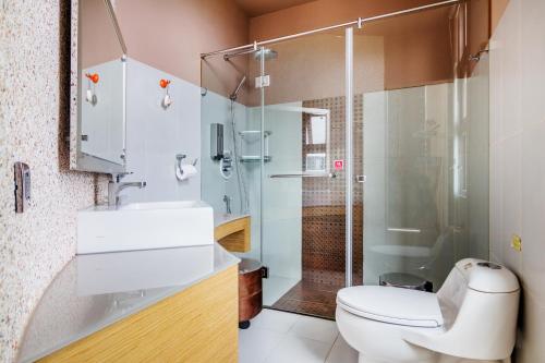 a bathroom with a toilet and a shower and a sink at Seaway in Magong