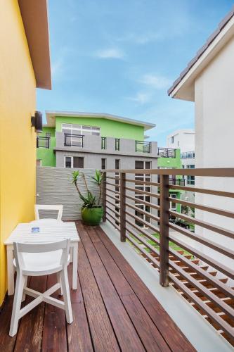a wooden deck with a white table and a building at Seaway in Magong