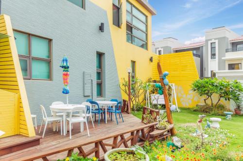 a deck with a table and chairs in a yard at Seaway in Magong