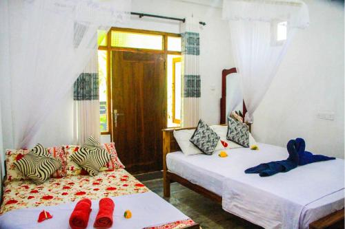 A bed or beds in a room at Amba Sewana Homestay
