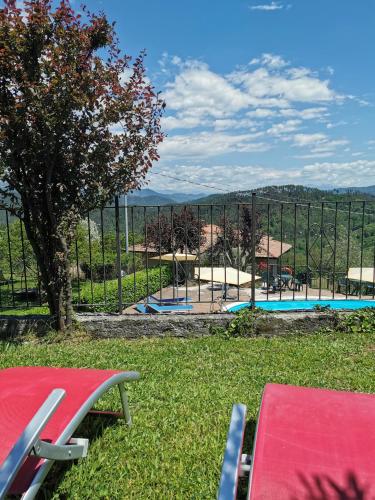 a view of a swimming pool behind a fence at Antiche Terre Hotel & Relax in Pignone