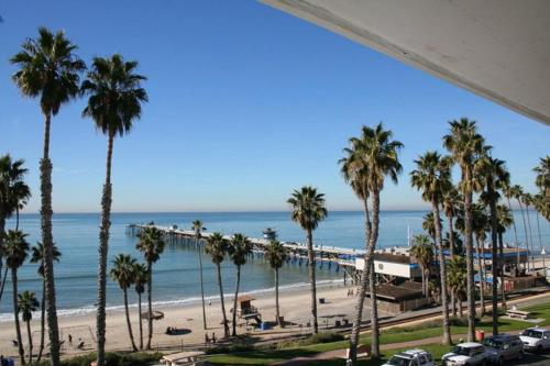 a view of a beach with palm trees and the ocean at Sea Horse Resort in San Clemente