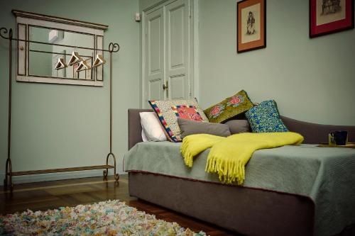 a bedroom with a bed with a yellow blanket on it at Look To in Turin