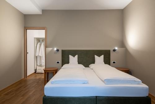 a bedroom with a large bed with white pillows at Residenz Feldmühle unterhalb der Burg Taufers in Campo Tures