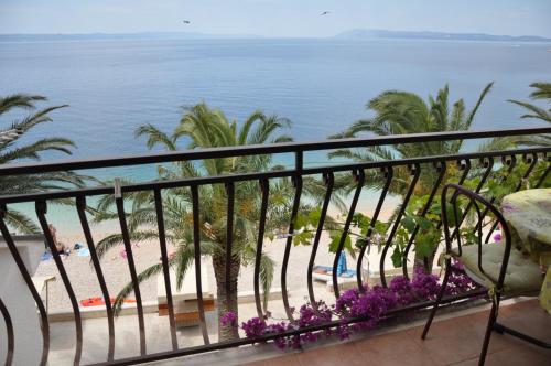 a view of the beach from the balcony of a resort at Villa DELFINA in Podgora