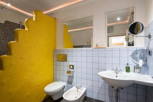 a bathroom with a white toilet and a sink at Residenz Feldmühle unterhalb der Burg Taufers in Campo Tures