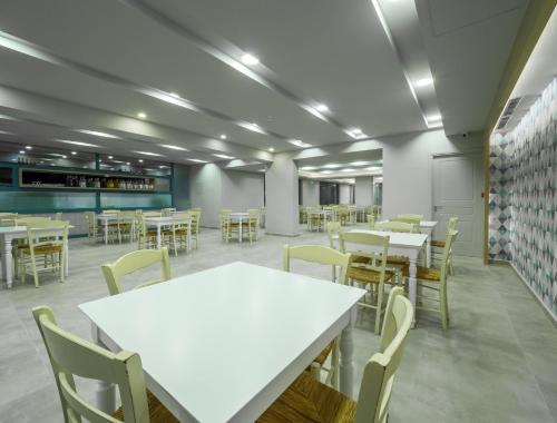 an empty cafeteria with tables and chairs in it at Paradise Resort in Finikounta