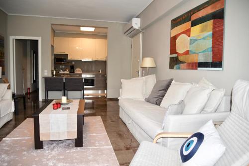 a living room with a white couch and a table at Amazing Apartment in Athens