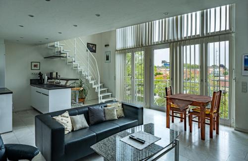 a living room with a couch and a table at Ferienwohnung Seerhein in Konstanz