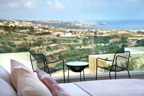 a living room with a couch and chairs on a balcony at Elea Silver Villa in Peyia
