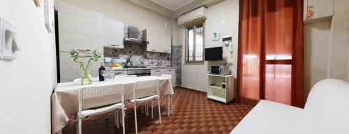 een keuken met een tafel en stoelen in een kamer bij Il sentiero del mare in Avola