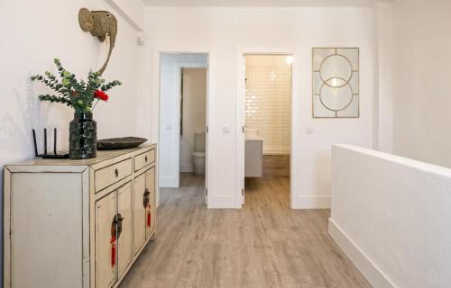 a living room with a cabinet and a hallway at FLH Altura Family House with Pool in Altura
