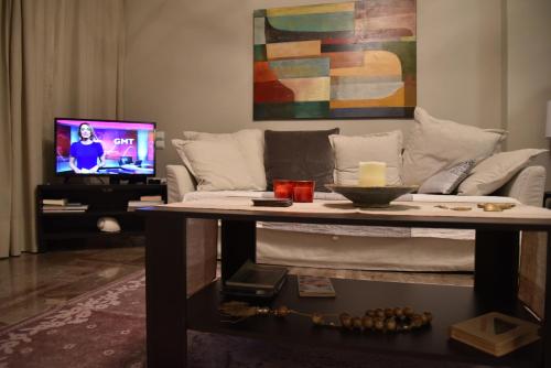a living room with a table and a couch at Amazing Apartment in Athens