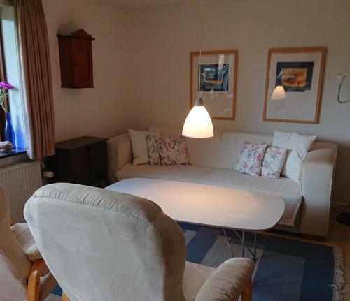 a living room with a couch and a table at B&B Hesselbjerg in Hesselbjerg