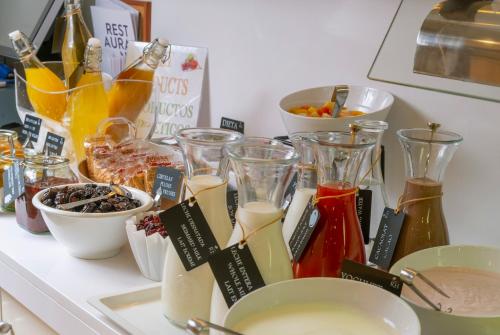 a counter topped with glasses and bowls of food at Hotel Rosamar Maxim 4*- Adults Only in Lloret de Mar