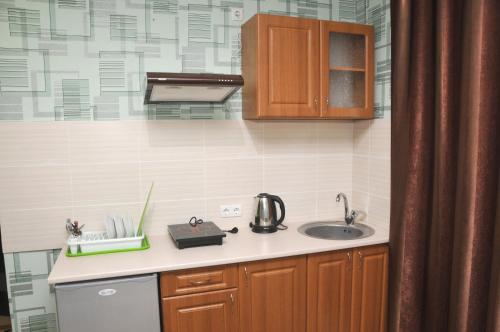 a kitchen with a sink and a counter top at Solnechnaia Dacha in Zatoka