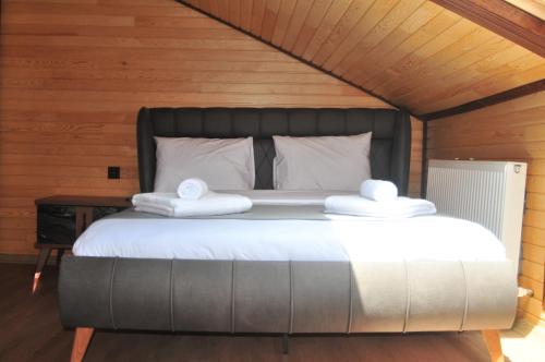 a bedroom with a bed with two towels on it at 61 Dilek Pansiyon in Uzungöl