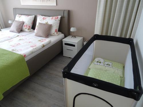 a small bedroom with a bed and a crib at FeWo Hage in Langelsheim