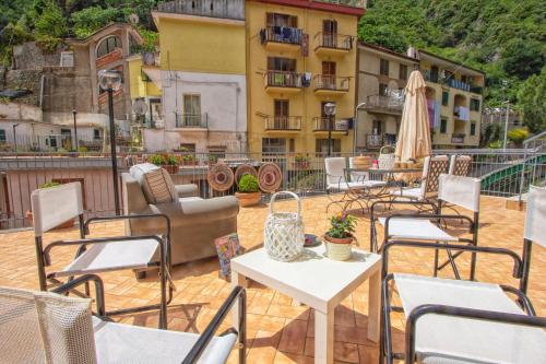 a group of chairs and tables on a patio at B&B Carol in Cetara