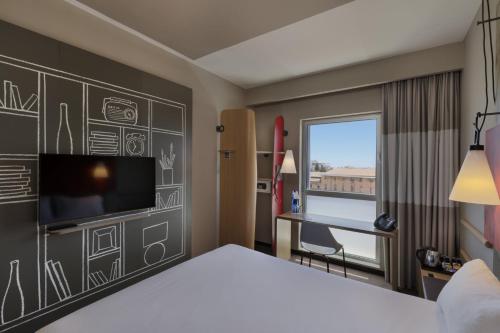 a room with a bed and a desk and a tv at ibis Jerusalem city Center - An AccorHotels Brand in Jerusalem