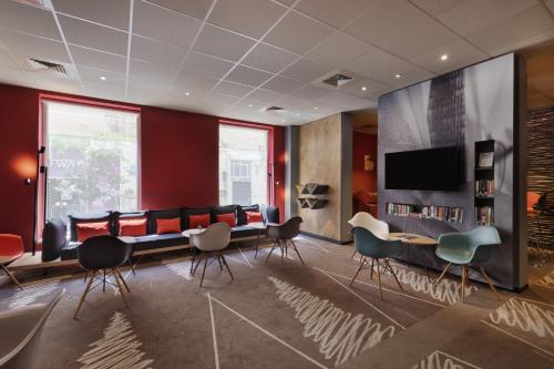 a conference room with chairs and a table and a tv at ibis Jerusalem city Center - An AccorHotels Brand in Jerusalem