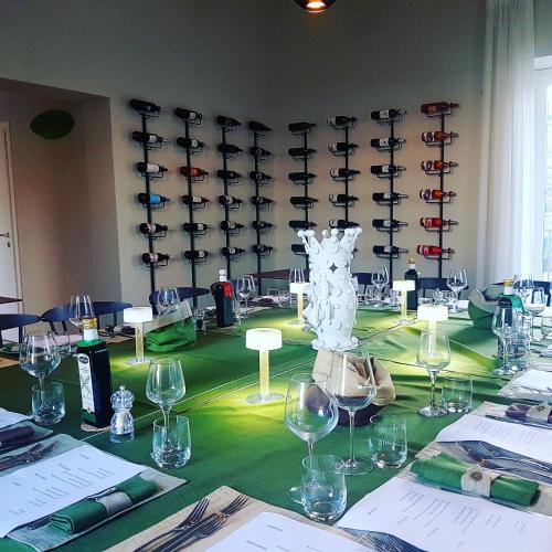 a room with a table with wine glasses on it at Kepos Etna Relais & Exclusive Spa in Santa Venerina