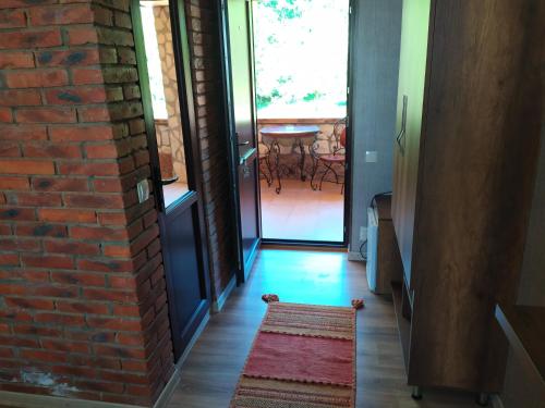 a hallway with a brick wall and a red rug at Chateau Chikovani in Gordi