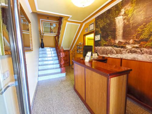 a lobby with a reception desk and a staircase at Hotel Liñares in Poio