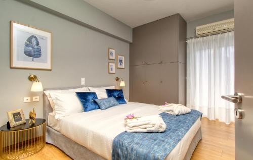 1 dormitorio con 1 cama grande con almohadas azules en Luxury penthouse apartment near the city center, en Heraclión