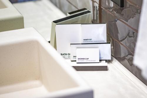 a pile of boxes sitting on a counter next to a sink at Warm House Apart Hotel in Almaty